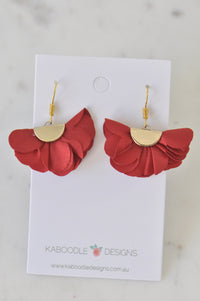 Pair of red fabric fan flower drop earrings on a Kaboodle Designs card, front view
