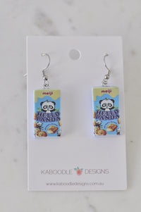 Pair of resin Hello Panda biscuit box drop earrings on a Kaboodle Designs card