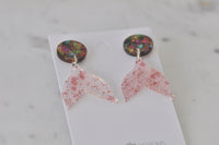 Pair of mermaid tail earrings angled to show sparkle and fin detail