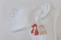 Close-up of Kath and Kim earring worn on a mannequin ear, showing acrylic finish and hook detail