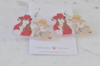 Pair of Kath and Kim acrylic earrings laid flat on marble surface beside Kaboodle Designs branded card