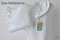 Single dreamcatcher earring shown on ear as size reference, hanging below earlobe