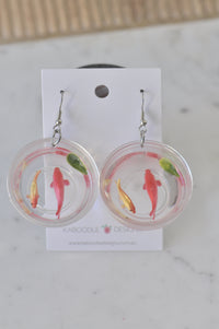 Pair of resin goldfish bowl earrings on card, showing pink and gold fish with a lily pad