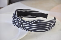Close-up of striped headband knot detail showing fabric texture