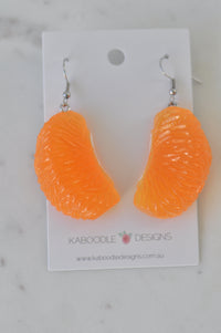 Pair of orange resin mandarin segment earrings on Kaboodle Designs card, front view