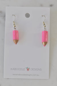 Pair of pink resin pencil dangle earrings with tan tips on Kaboodle Designs card