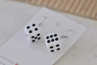 White dice earrings on Kaboodle card, close-up of black dot faces showing five and six