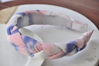 Angled close-up of the braided headband highlighting the pink, lilac and white weave