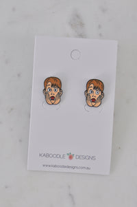Pair of Kevin face enamel stud earrings on a Kaboodle Designs card, hands on cheeks and mouth open