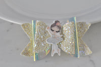 Close-up of glitter bow hair clip showing iridescent trim and ballerina detail