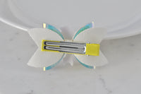 Back view of glitter ballerina hair clip showing yellow ribbon and metal clip