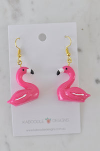 Pair of hot pink resin flamingo drop earrings on Kaboodle Designs card, front view