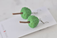 Close-up rear view of resin tree earrings showing trunk detail and silver hook