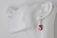 Strawberry jam jar earring shown worn on an ear for scale