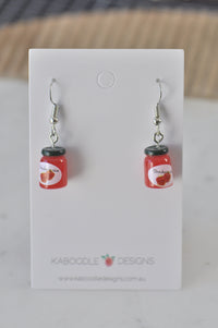 Pair of miniature strawberry jam jar resin earrings on a Kaboodle Designs display card