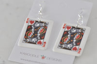 Close-up of King of Hearts card earrings showing glossy acrylic finish and print detail
