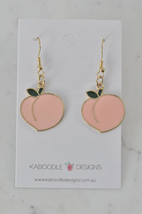 Pair of pink enamel peach drop earrings with gold outline on Kaboodle Designs card
