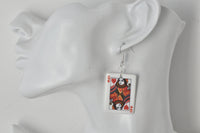 Close-up of Queen of Hearts card earring worn on ear, showing card detail
