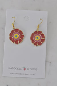 Pair of red enamel flower drop earrings with pink, yellow and blue centres on a Kaboodle card