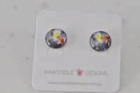 Pair of round geometric stud earrings on Kaboodle Designs card, showing blue, grey, yellow and orange triangle pattern
