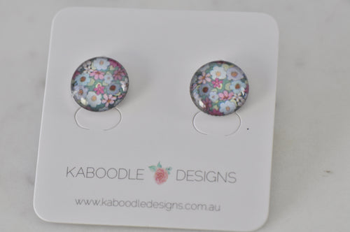 Round floral artwork stud earrings on Kaboodle Designs card, pink and blue flower pattern