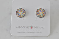 Round stud earrings with colourful yellow, blue and pink mosaic square pattern, pinned to Kaboodle Designs card