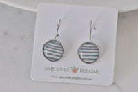 Round silver-tone dangle earrings with blue, pink and cream stripe pattern on Kaboodle card