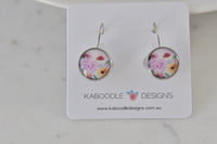Round floral leverback earrings with pink rose print displayed on Kaboodle Designs card