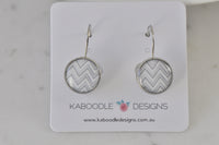 Round chevron pattern earrings in grey and white on silver-tone leverback, displayed on Kaboodle Designs card