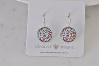 Round floral leverback earrings on Kaboodle Designs card, showing red, pink and purple flower print