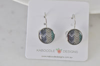 Round silver-tone leverback earrings with black, white and teal chevron pattern on Kaboodle card