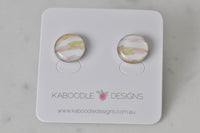 Round handmade stud earrings on Kaboodle Designs card, abstract pink and green watercolour pattern