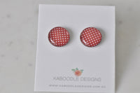 Round red stud earrings with white polka dot pattern, glossy finish, on Kaboodle Designs card