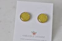 Round stud earrings with yellow and black polka dot pattern on Kaboodle Designs card