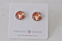 Round stud earrings with orange poppy artwork print on cream background, on Kaboodle Designs card