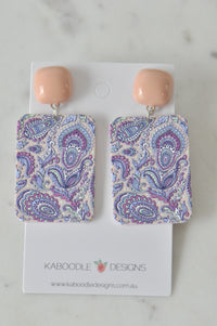 Pair of rectangular paisley print drop earrings with peach studs on Kaboodle card