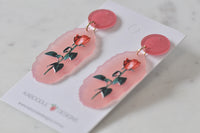 Angled view of both rose earrings showing scalloped edge and gold jump ring detail