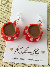 Red polkadot teacup earrings laid flat on Kaboodle Designs branded card