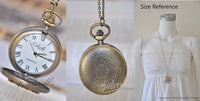 Frida Kahlo pocket watch necklace showing open dial face, engraved back, and size reference on model