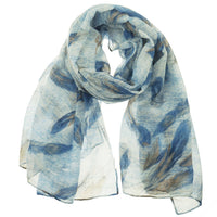 Blue feather print scarf loosely knotted, showing full drape and length