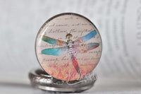 Close-up of dragonfly design on pocket watch necklace pendant