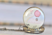 Close up of hot air balloon and rainbow pocket watch pendant design