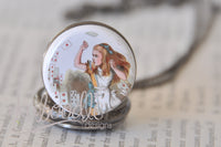 Close-up of pocket watch pendant lid showing Alice in Wonderland playing cards illustration