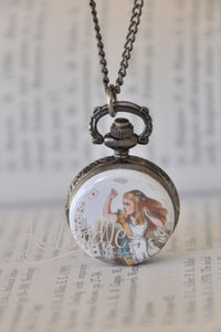 Alice in Wonderland pocket watch necklace pendant displayed against a book background