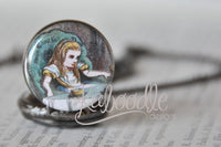 Close-up of Alice in Wonderland illustration cabochon on pocket watch pendant