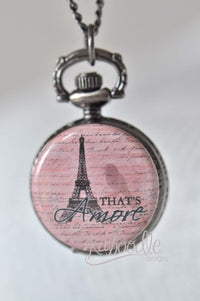 Pocket watch necklace pendant with Eiffel Tower and "That's Amore" text on pink script background