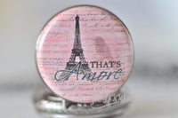 Close-up of Eiffel Tower and "That's Amore" design on pocket watch pendant face