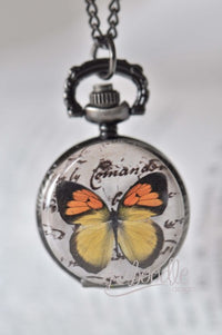 Pocket watch necklace with butterfly design over vintage script on the front cover