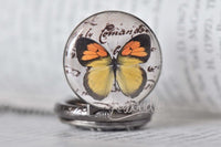 Close-up of the butterfly cabochon design on the pocket watch necklace pendant