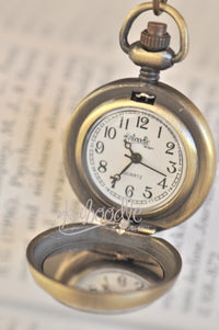 Open pocket watch necklace showing Quartz watch face and Kaboodle Designs branding